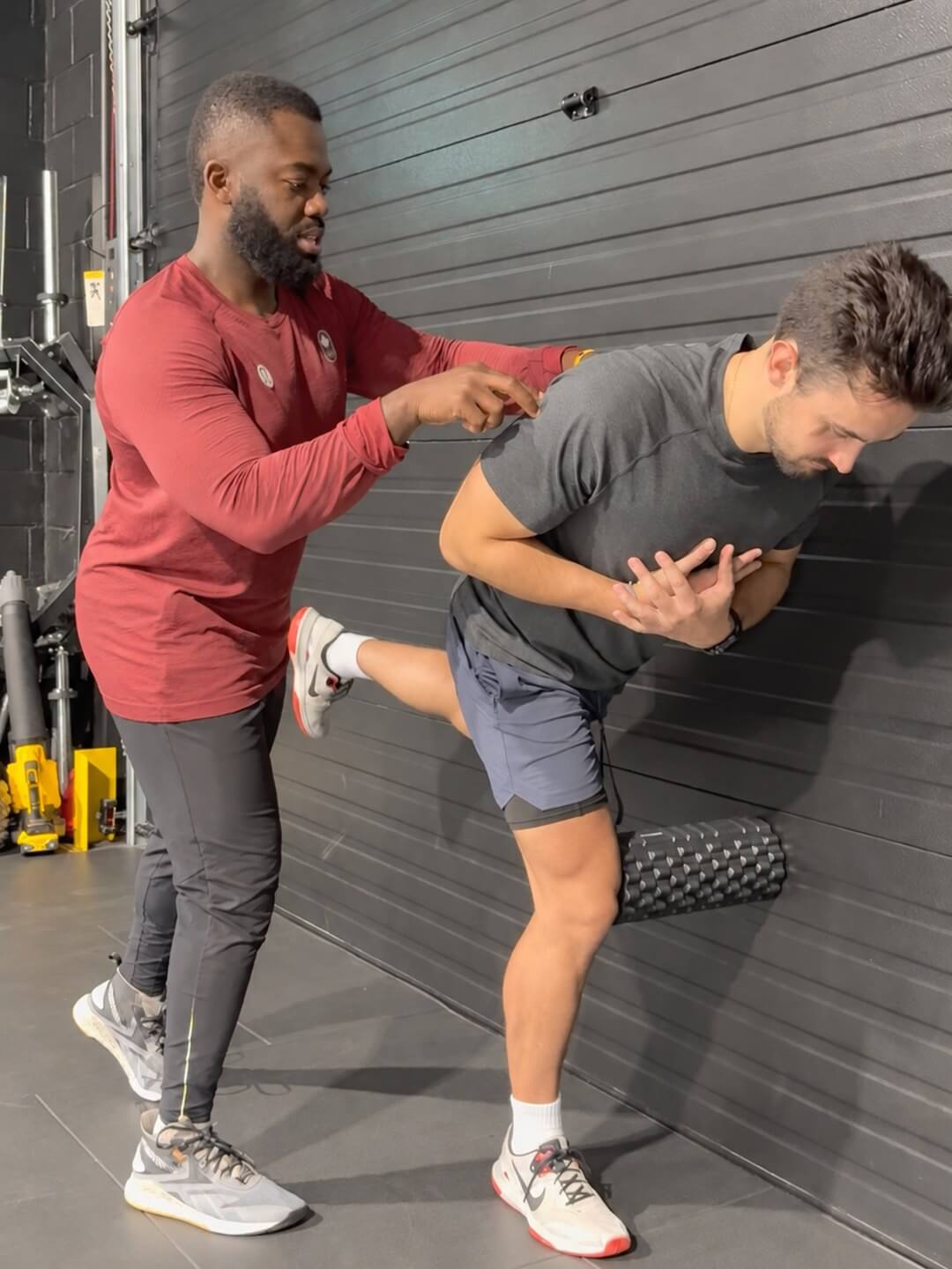 Doug cueing a client through a stretch against the wall.